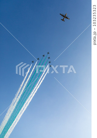 Bomber leading fighter jets squadron with traces in Saudi Arabian national flag colors, at Jeddah air show Bomber leading fighter jets squadron with traces in Saudi Arabian national flag colors, at Jeddah air show 103235323