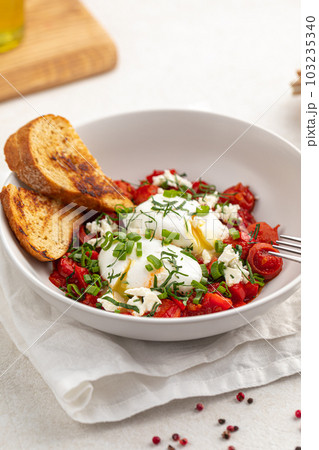 Gourmet breakfast with poached eggs and tomatoes Gourmet breakfast with poached eggs and tomatoes 103235340