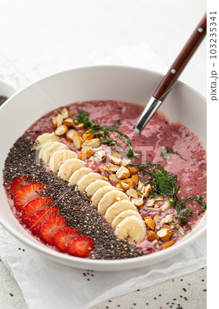 Healthy smoothie bowl with banana and strawberries Healthy smoothie bowl with banana and strawberries 103235341
