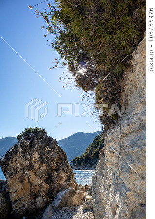 White rocks vertical cliff with greenery, Greece White rocks vertical cliff with greenery, Greece 103235976