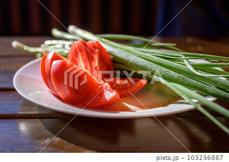 close-up of a plate of fresh raw vegetables on a wooden table. close-up of a plate of fresh raw vegetables on a wooden table. 103236887