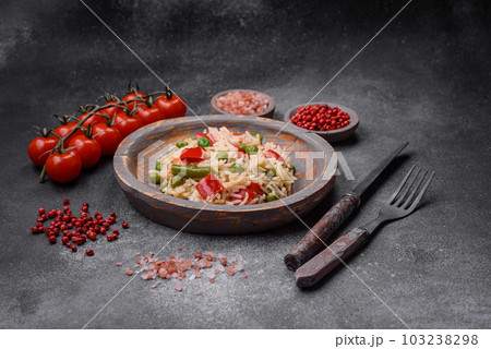 Delicious boiled rice with peppers, peas, asparagus beans and carrots 103238298