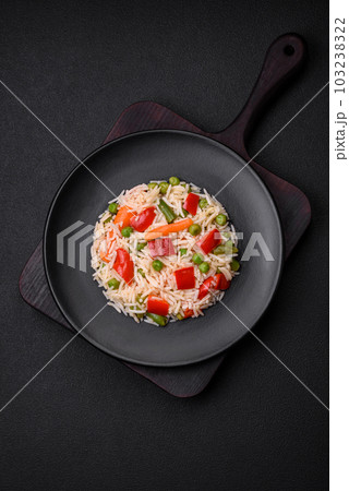 Delicious boiled rice with peppers, peas, asparagus beans and carrots 103238322