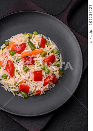 Delicious boiled rice with peppers, peas, asparagus beans and carrots 103238325