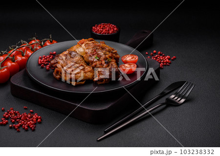 Delicious fried chicken in sauce with onions, salt, spices and herbs 103238332