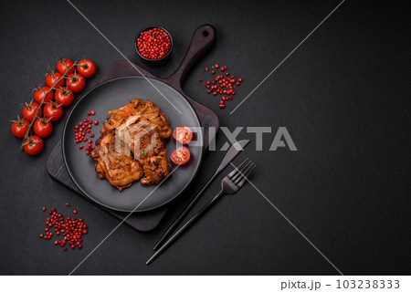 Delicious fried chicken in sauce with onions, salt, spices and herbs 103238333
