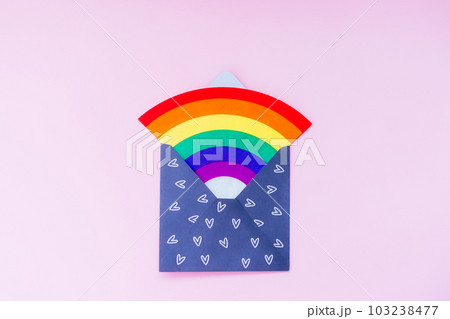 Rainbow in open paper envelope with hearts on the pink background. LGBT flag. LGBTQIA Pride Month concept. Lesbian gay bisexual transgender. Gender equality. Human rights and tolerance. Copy space. 103238477