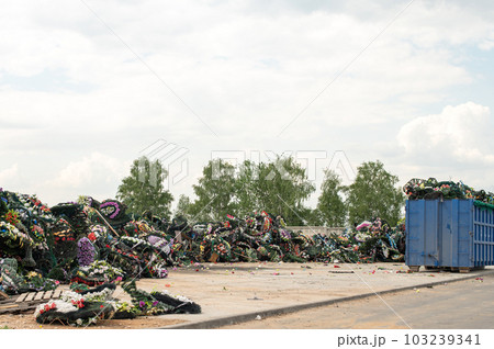 A mountain of plastic waste in the cemetery. Environmental pollution by plastic. A mountain of plastic waste in the cemetery. Environmental pollution by plastic. 103239341