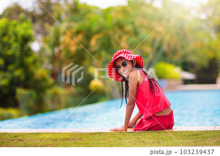 Child in swimming pool on ring toy. Kids swim. Child in swimming pool on ring toy. Kids swim. 103239437