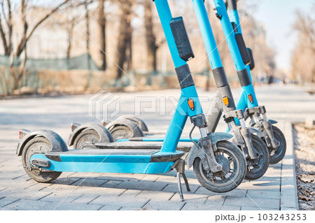 Electric Scooters For Public Use, Standing On The Street In The City Center. Public mobile transport. urban eco-friendly transport for rent 103243253
