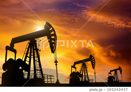 Oil pump oil rig energy industrial machine in Colorful dramatic sky Oil pump oil rig energy industrial machine in Colorful dramatic sky 103243437