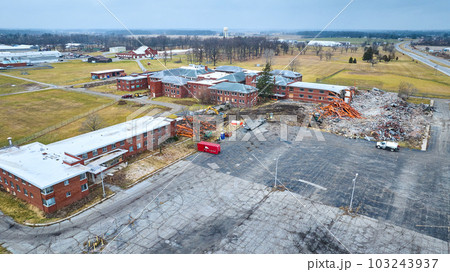 Drone aerial of construction site of deconstruction of old abandoned hospital building with decay at Byron Health Center 103243937
