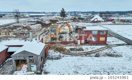Sky view of an old abandoned building being torn down in winter 103243961