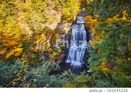 Large waterfall from above surrounded by colorful forests Large waterfall from above surrounded by colorful forests 103245226