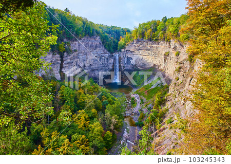 Fall forests around giant rocky canyon and large waterfall Fall forests around giant rocky canyon and large waterfall 103245343