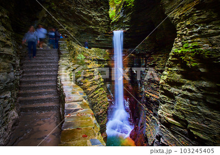 Stone steps lead around and beyond amazing waterfall in gorge of Upstate New York 103245405