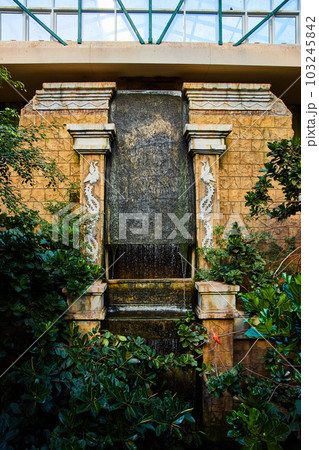 Temple display in bird exhibit with forest and manmade waterfall Temple display in bird exhibit with forest and manmade waterfall 103245842