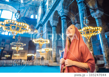 INSCRIPTION - denoting the names of Allah, the Prophet Muhammad, as well as the first 4 caliphs Woman tourist enjoying Hagia Sofia, Ayasofya interior in Istanbul, Turkey, Byzantine architecture, city 103247044