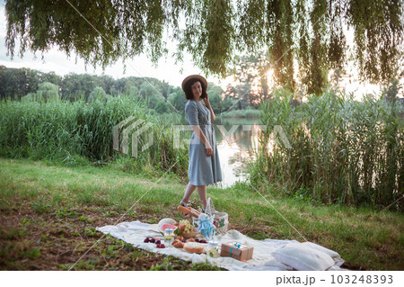 A young woman going on a picnic in a park A young woman going on a picnic in a park 103248393