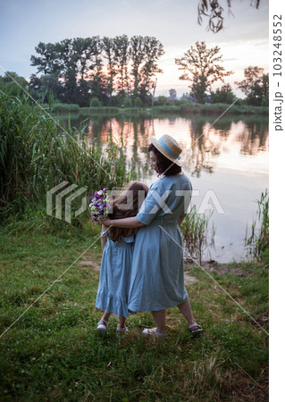 the mother hugging daughter outdoor in the nature 103248552