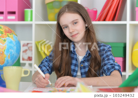 girl drawing picture at home at the table 103249432