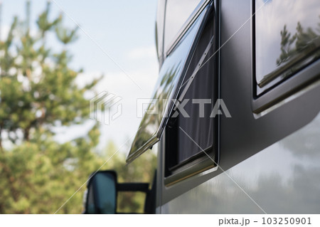 Close-up of a window in a motorhome, rest in a van Close-up of a window in a motorhome, rest in a van 103250901