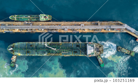 Aerial top view oil tanker ship at terminal industrial port tugboat drag crude oil tanker ship park to port for transfer crude oil to oil refinery, Global business import export transportation 103251169