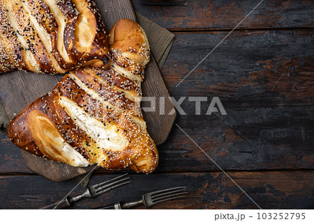 Burekas triangle filled with cheese painir , on old dark  wooden table background, top view flat lay, with copy space for text 103252795
