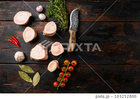 Raw beef marrow bones, on old dark wooden table background, top view flat lay, with copy space for text Raw beef marrow bones, on old dark wooden table background, top view flat lay, with copy space for text 103252800