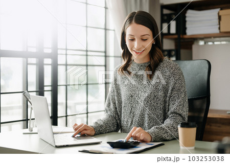 Woman freelancer is working her job on computer tablet and laptop Doing accounting analysis report real estate investment data, Financial at office. Woman freelancer is working her job on computer tablet and laptop Doing accounting analysis report real estate investment data, Financial at office. 103253038