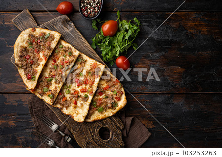 Pide with minced meat Turkish Kiymali Pide, on old dark wooden table background, top view flat lay, with copy space for text Pide with minced meat Turkish Kiymali Pide, on old dark wooden table background, top view flat lay, with copy space for text 103253263
