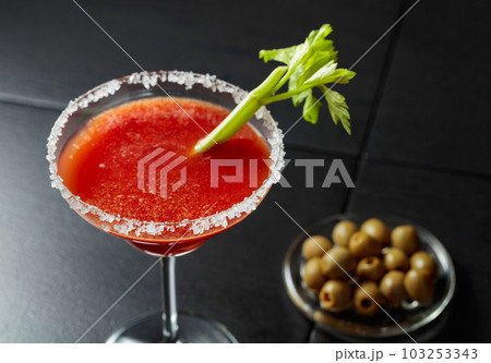 Bloody Mary cocktail with celery and green olives. Bloody Mary cocktail with celery and green olives. 103253343