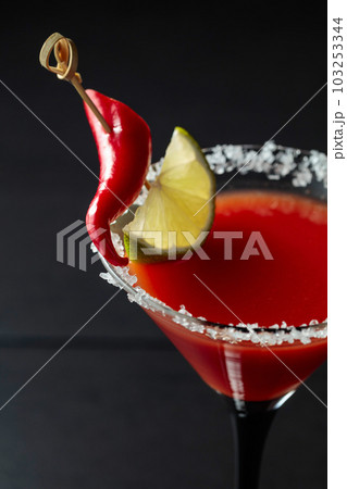 Bloody Mary cocktail with lime and red pepper. 103253344