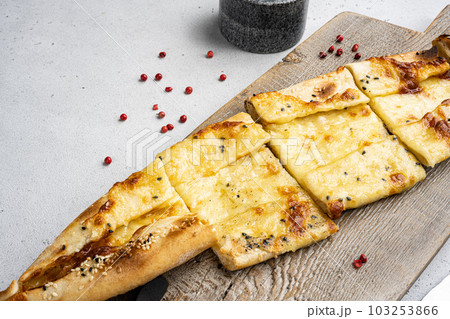 Traditional Turkish baked pide dish, on gray concrete table background, with copy space for text 103253866