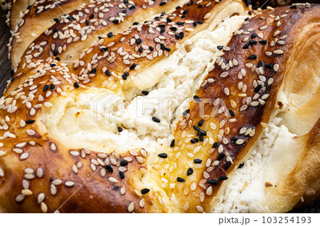 Traditional feta cheese phyllo pastry Turkish pie, on old dark wooden table background, close up macro Traditional feta cheese phyllo pastry Turkish pie, on old dark wooden table background, close up macro 103254193
