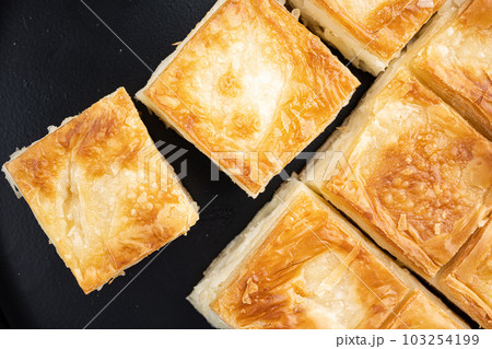 Cheesy pastry, butter pastry, top view flat lay, on black dark stone table background 103254199