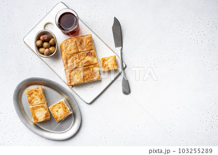 Su Boregi pie, Turkish Tabla borek or burek, on gray concrete table background, top view flat lay, with copy space for text Su Boregi pie, Turkish Tabla borek or burek, on gray concrete table background, top view flat lay, with copy space for text 103255289
