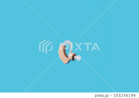 Hearing aid flies against a blue background Hearing aid flies against a blue background 103256199