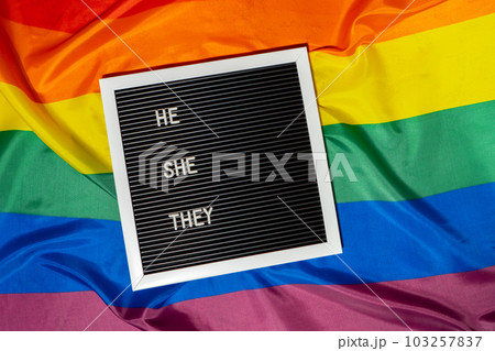 HE SHE THEY text Neo pronouns concept on Rainbow flag background gender pronouns. Non-binary people rights transgenders. Lgbtq community support assume my gender tolerance equal rights HE SHE THEY text Neo pronouns concept on Rainbow flag background gender pronouns. Non-binary people rights transgenders. Lgbtq community support assume my gender tolerance equal rights 103257837