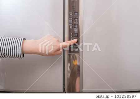 【冷蔵室の温度調整ボタンを押す主婦】 103258597