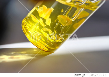 Serum with beautiful yellow petals close-up. Macro. Serum with beautiful yellow petals close-up. Macro. 103259058