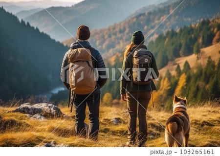 Couple with a backpack hiking with his beautiful dog in the mountains. Concept a sense of adventure and freedom. Generative Ai 103265161