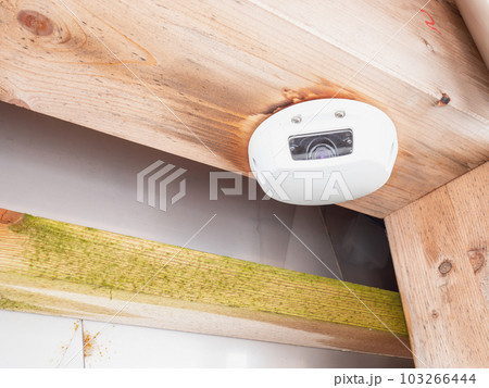 Surveillance camera inside the room on the wall, close view 103266444