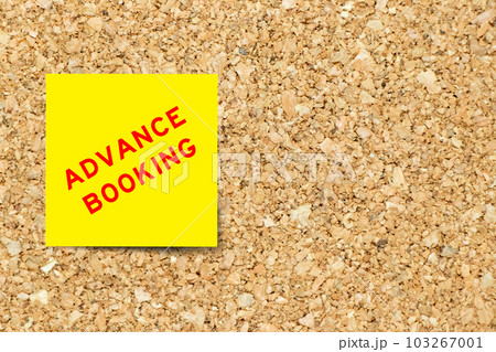 Yellow note paper with word advance booking on cork board background with copy space Yellow note paper with word advance booking on cork board background with copy space 103267001