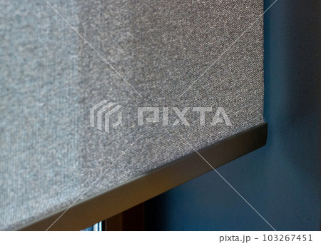 Roller blind close-up, detailed. Sunscreen fabric for the roller shades. Selective fokus. Roller blind close-up, detailed. Sunscreen fabric for the roller shades. Selective fokus. 103267451