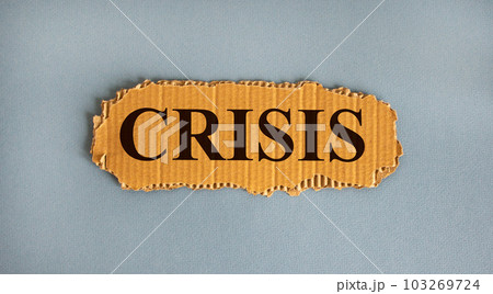 Word 'crisis' on the piece of cardboard on a beautiful white background, copy space. 103269724