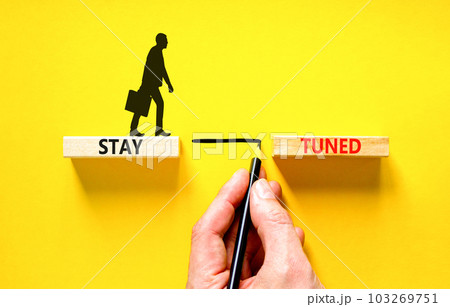 Stay tuned symbol. Concept words Stay tuned on wooden blocks on beautiful yellow table yellow background. Businessman hand. Business, support, motivation, psychological stay tuned concept. Copy space. Stay tuned symbol. Concept words Stay tuned on wooden blocks on beautiful yellow table yellow background. Businessman hand. Business, support, motivation, psychological stay tuned concept. Copy space. 103269751