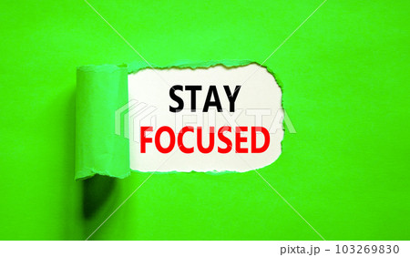 Stay focused symbol. Concept words Stay focused on beautiful white paper on a beautiful green background. Business, support, motivation, psychological and stay focused concept. Copy space. Stay focused symbol. Concept words Stay focused on beautiful white paper on a beautiful green background. Business, support, motivation, psychological and stay focused concept. Copy space. 103269830