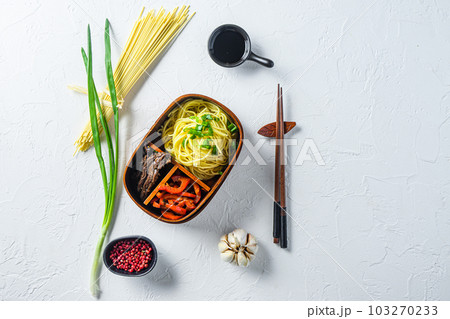 Homemade Bento pack lunch, grilled beef and noodles with ingredients top view space for text. Homemade Bento pack lunch, grilled beef and noodles with ingredients top view space for text. 103270233