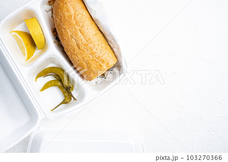 Tantuni doner kebab Somun ekmek tavuk, in plastic pack container delivery lunch box, on white stone table background, top view flat lay, with copy space for text Tantuni doner kebab Somun ekmek tavuk, in plastic pack container delivery lunch box, on white stone table background, top view flat lay, with copy space for text 103270366